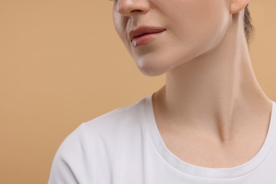 Photo of Beauty concept. Woman on beige background, closeup