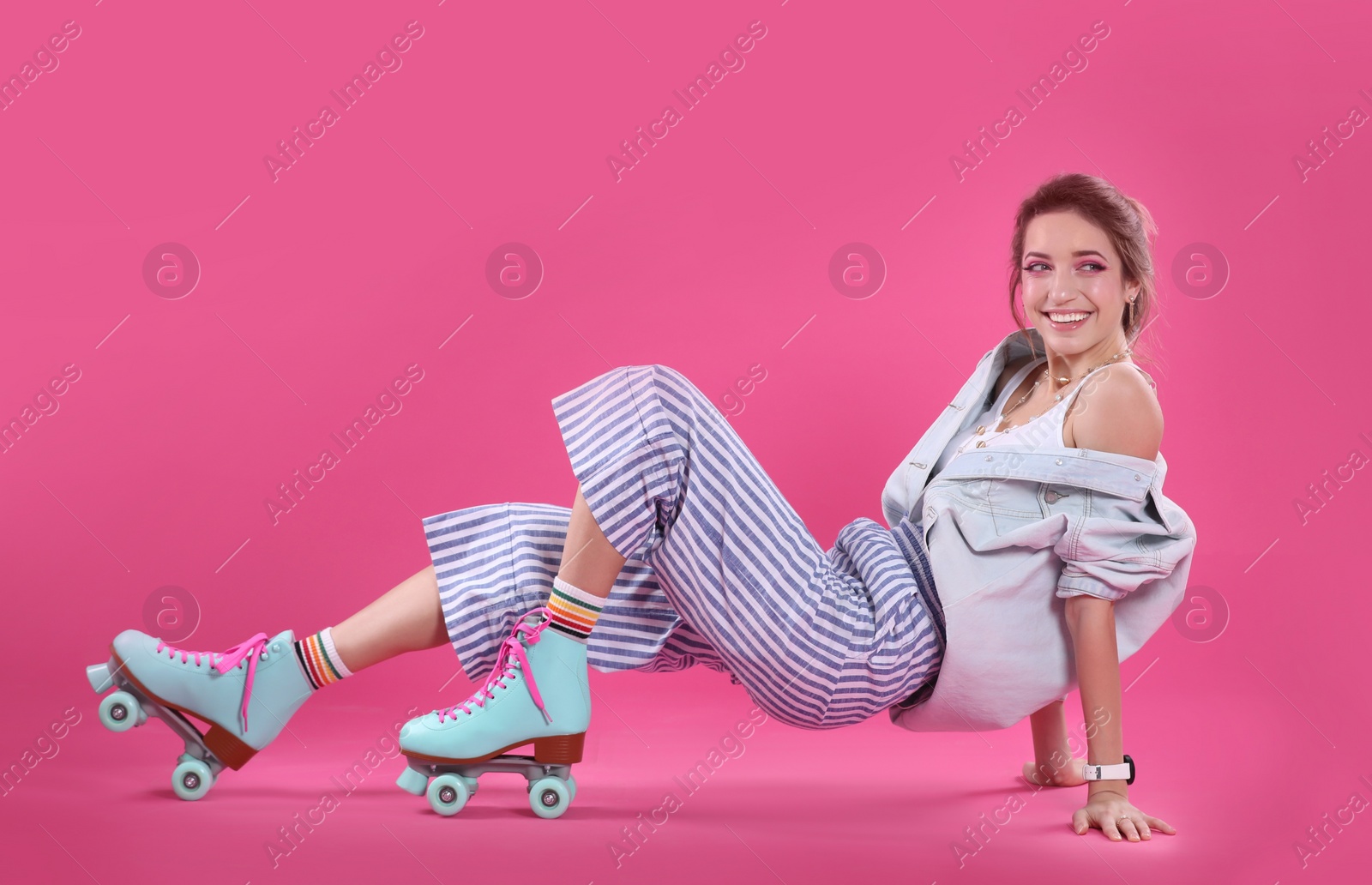 Photo of Young woman with retro roller skates on color background