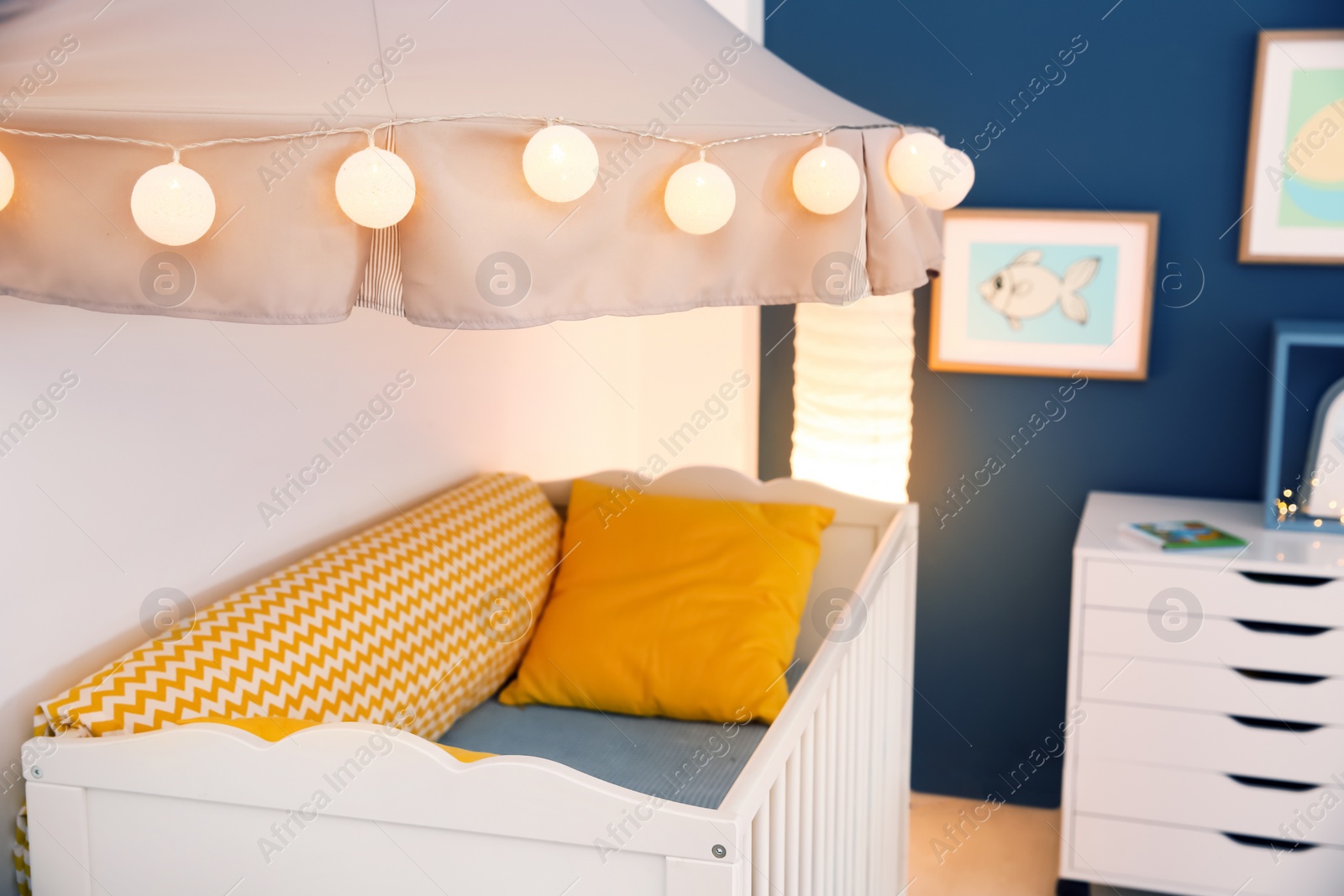 Photo of Stylish baby room interior with crib