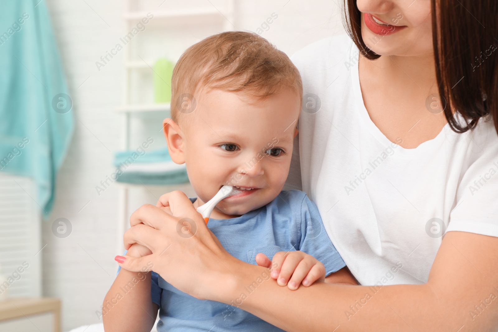 Photo of Woman and her son with toothbrush on blurred background