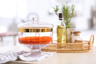 Photo of Red lentil on wooden table in modern kitchen