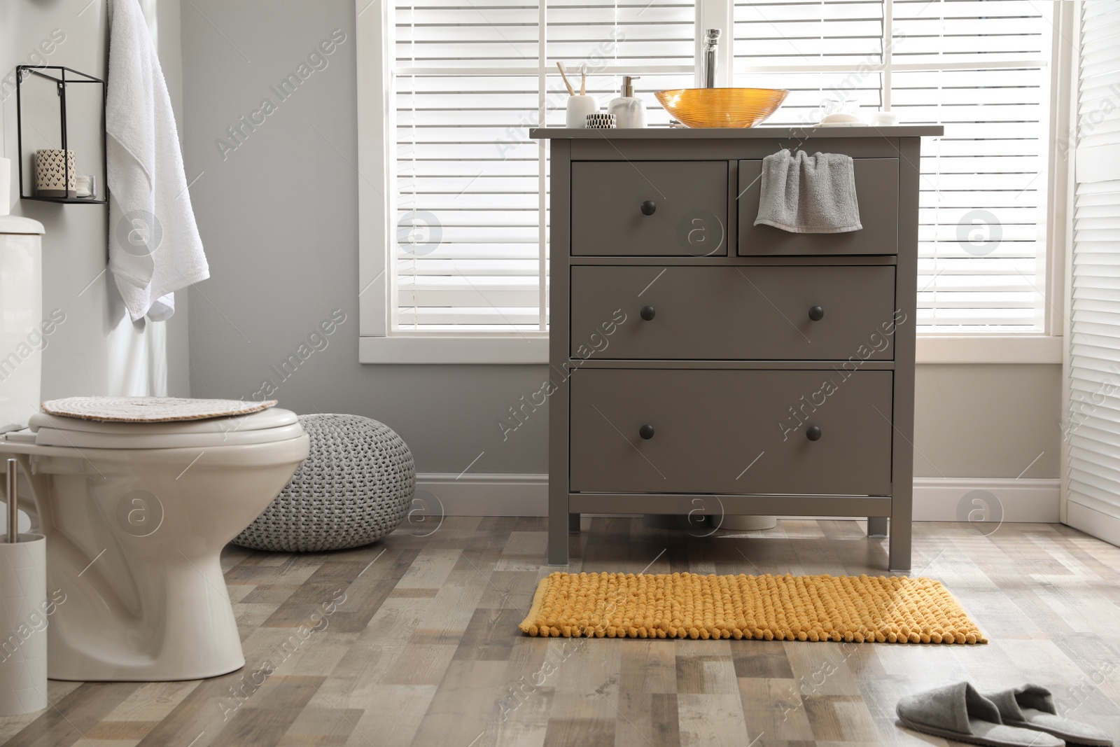 Photo of Mat near base cabinet with sink in bathroom