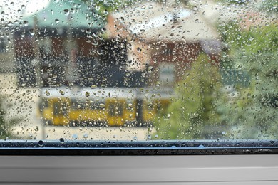 Photo of Window glass with drops of condensate indoors, closeup