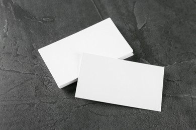 Photo of Blank business cards on grey table, above view. Mockup for design