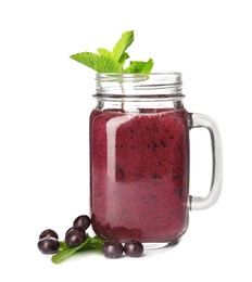 Mason jar with delicious acai smoothie on white background