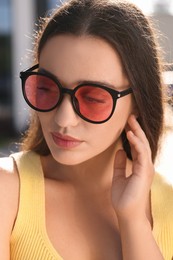 Beautiful woman in sunglasses outdoors on sunny day