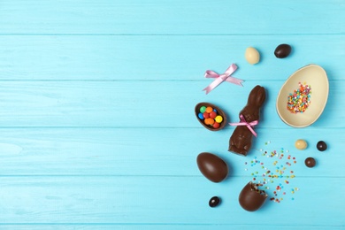 Photo of Flat lay composition with chocolate Easter eggs and space for text on wooden background