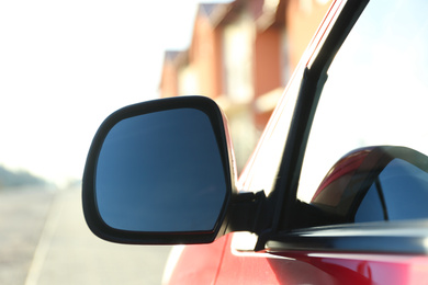 Side rear view mirror of modern car outdoors