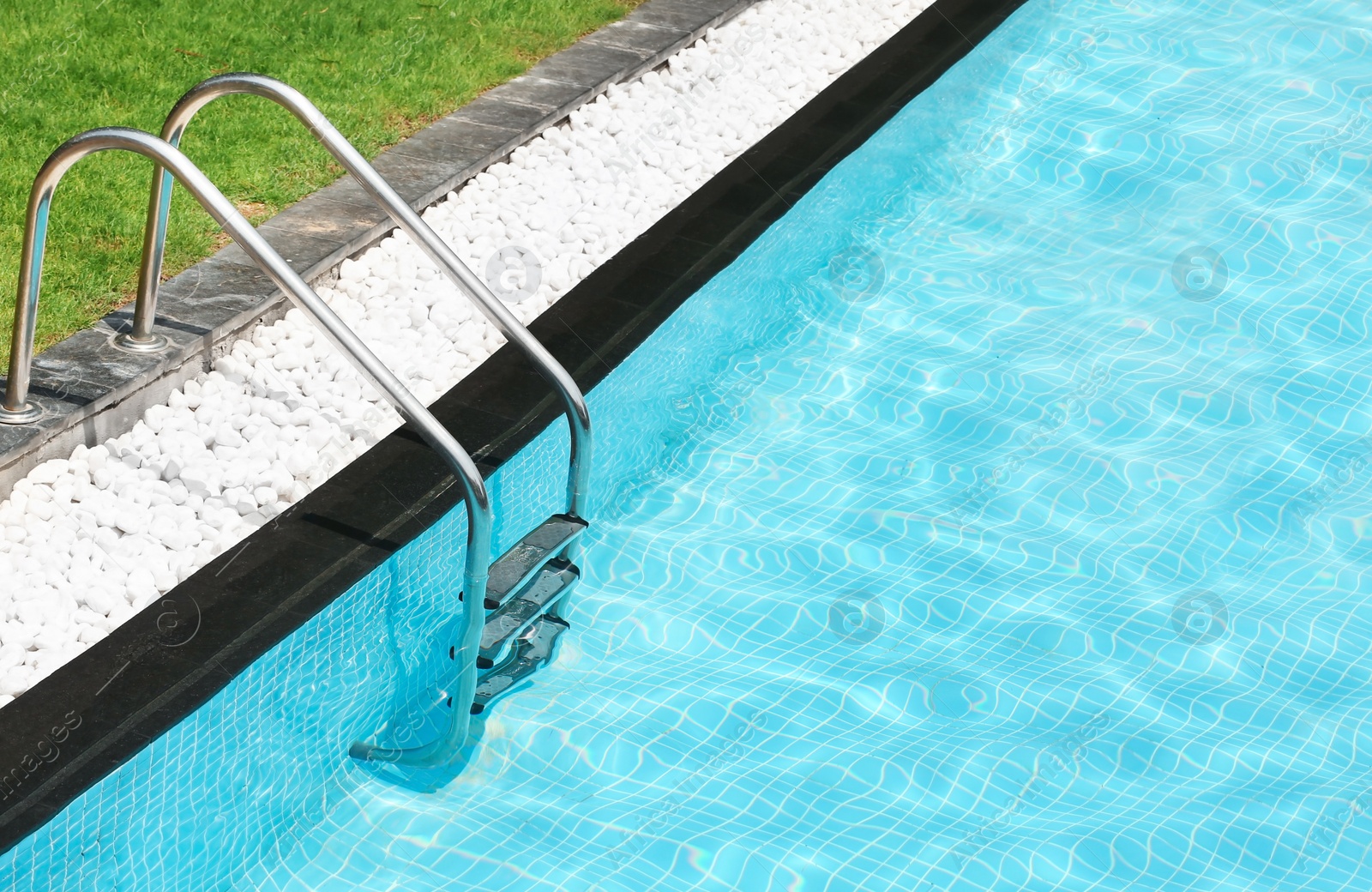 Photo of Modern swimming pool with stairs at resort