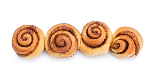 Photo of Many tasty cinnamon rolls isolated on white, top view