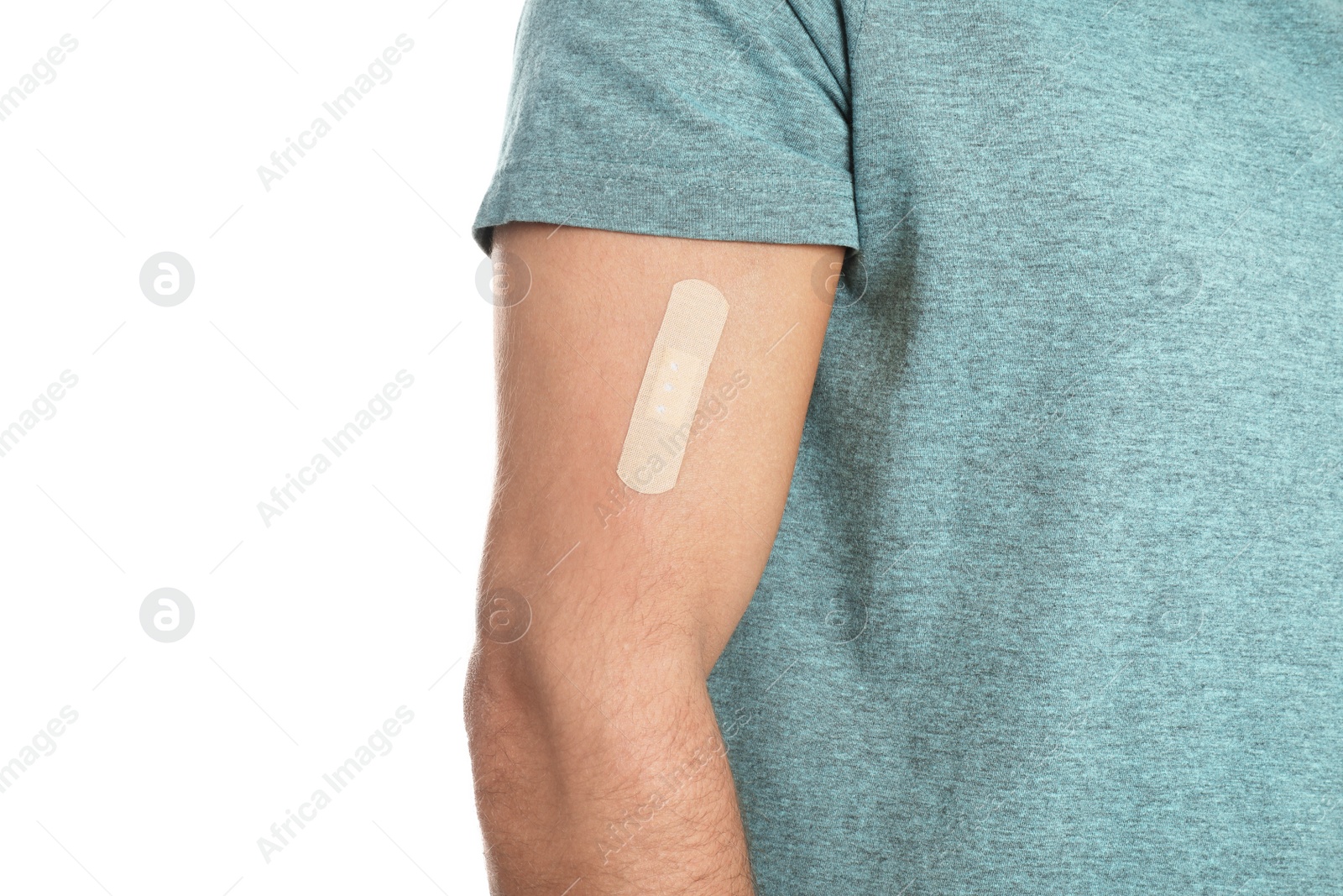 Photo of Man with sticking plaster on arm against white background, closeup