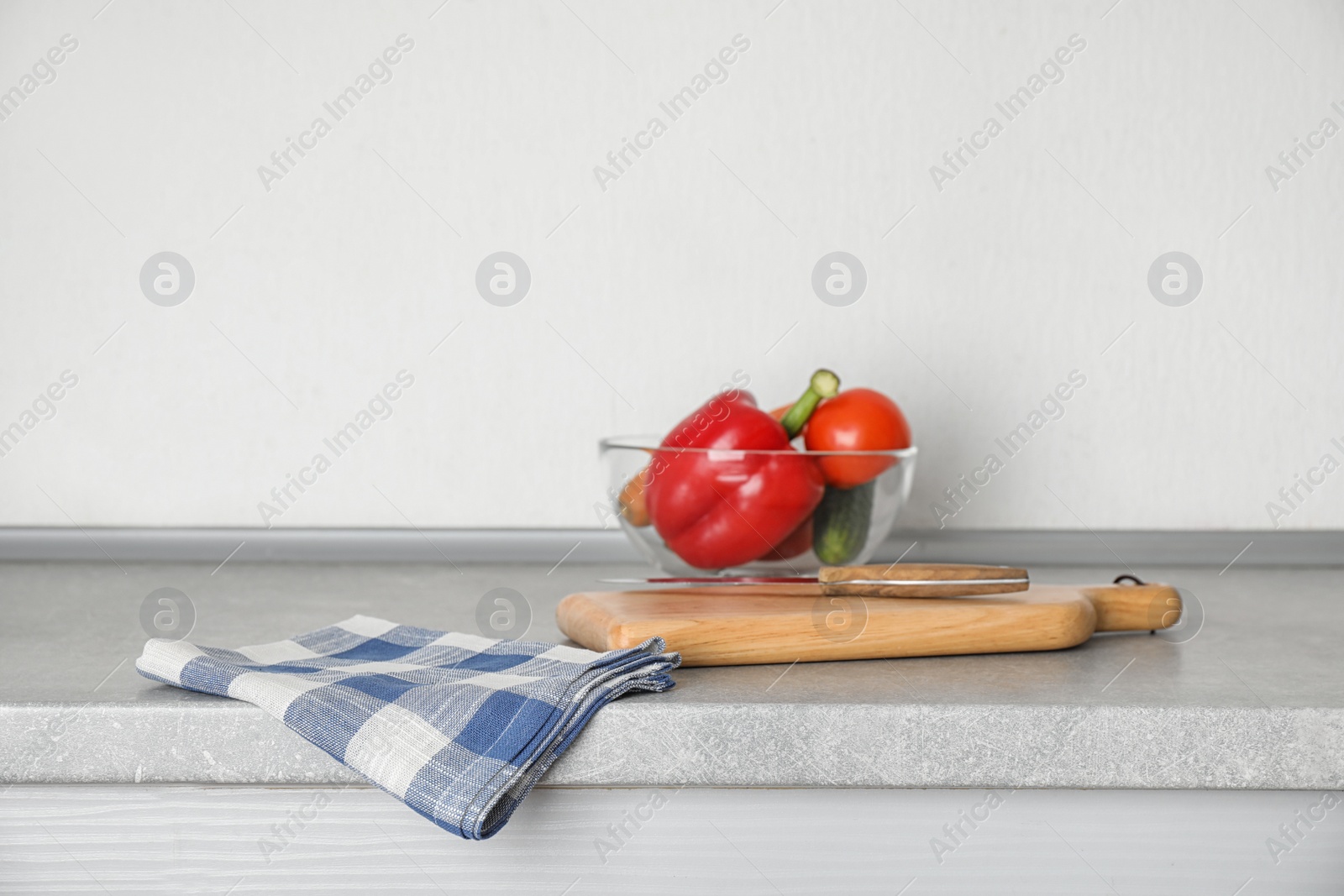 Photo of Fabric checkered towel on table in kitchen