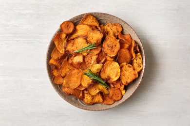 Photo of Plate of sweet potato chips on light table, top view