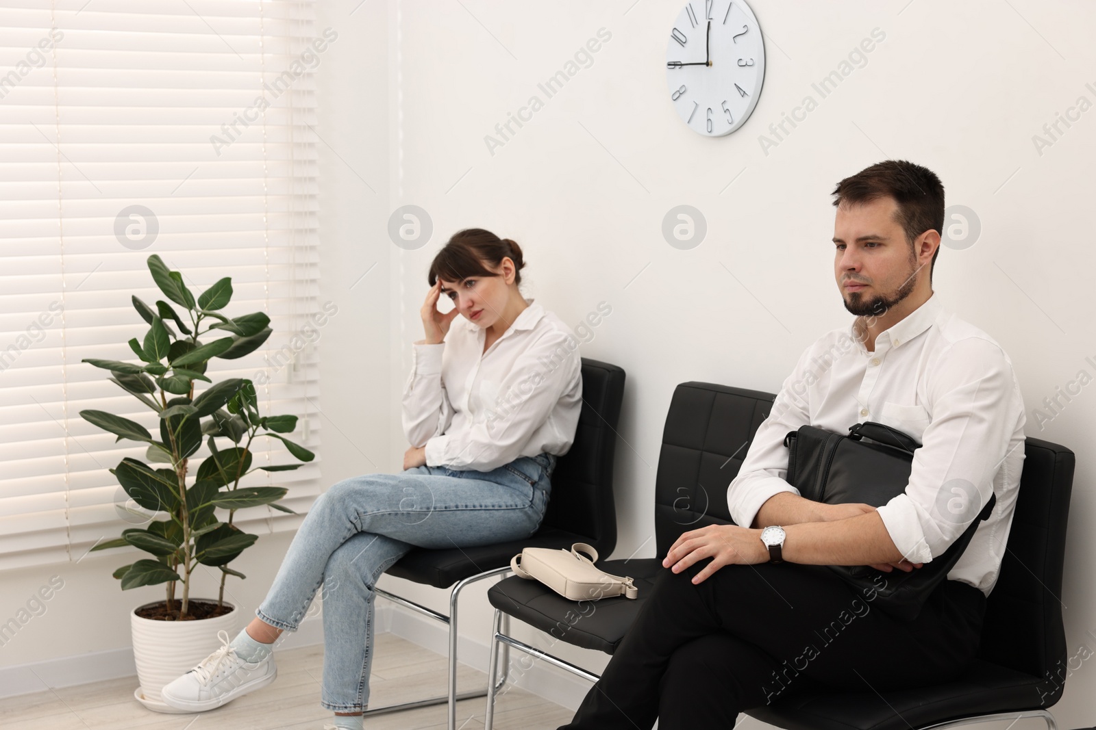 Photo of Man and woman waiting for job interview indoors