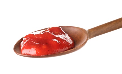 Photo of Wooden spoon with red sauce on white background