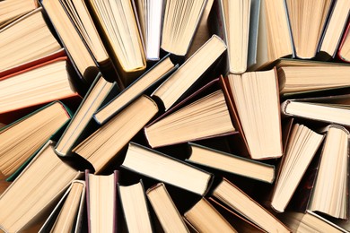 Photo of Many hardcover books as background, top view. Library material