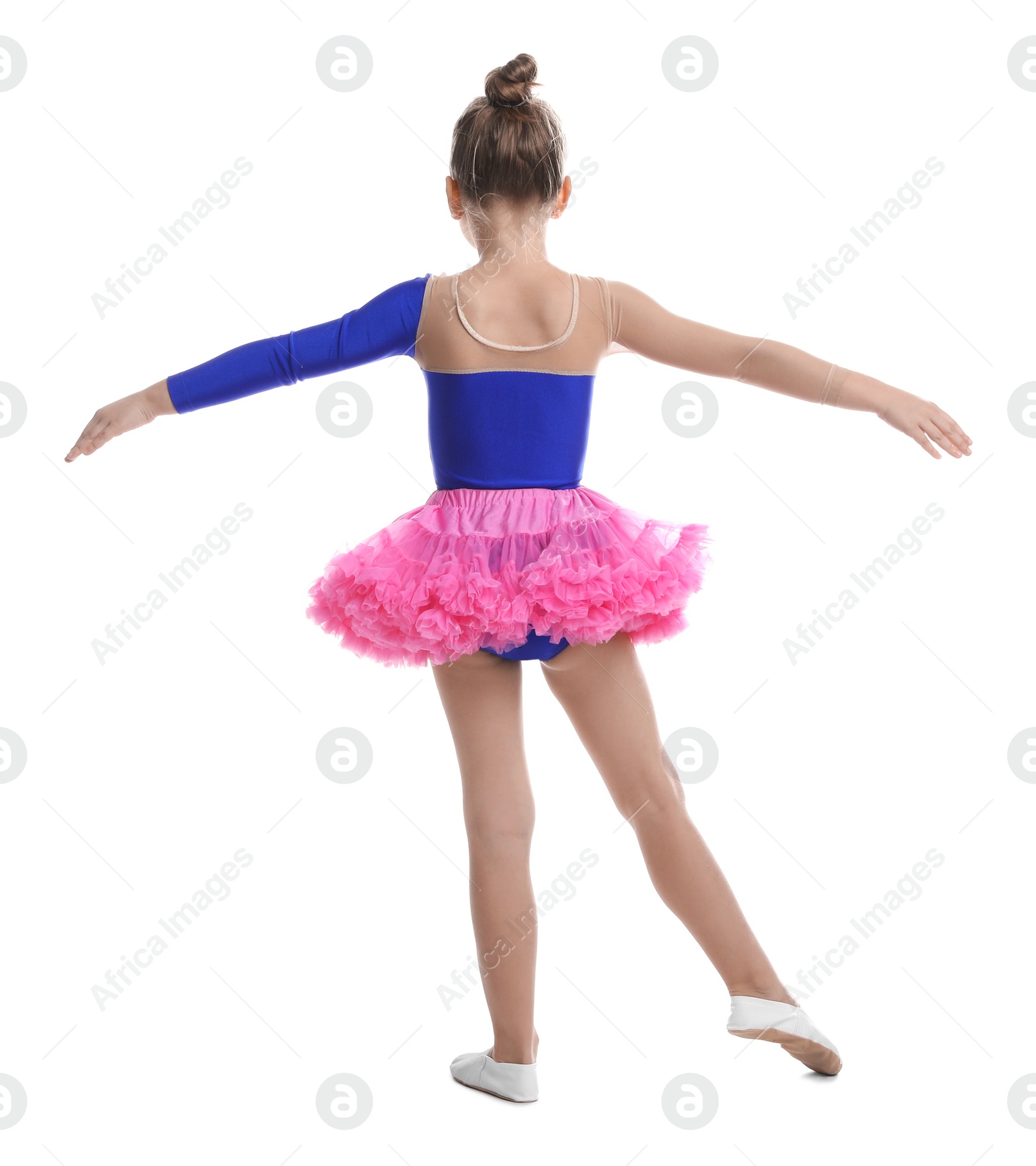 Photo of Cute little girl in costume dancing on white background, back view