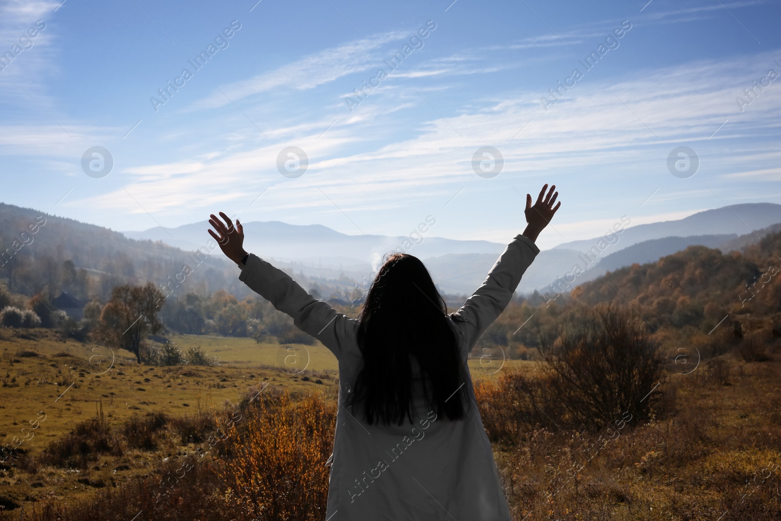 Photo of Female traveler feeling free in peaceful mountains