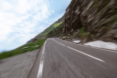 Image of Asphalt road along crag without transport, motion blur effect