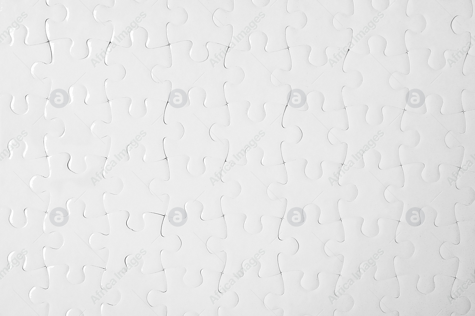 Photo of Blank white puzzle as background, top view