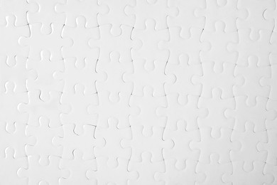 Photo of Blank white puzzle as background, top view