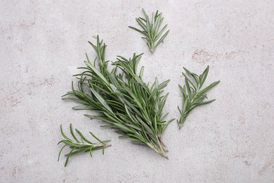 Photo of Sprigs of rosemary on light gray background, flat lay