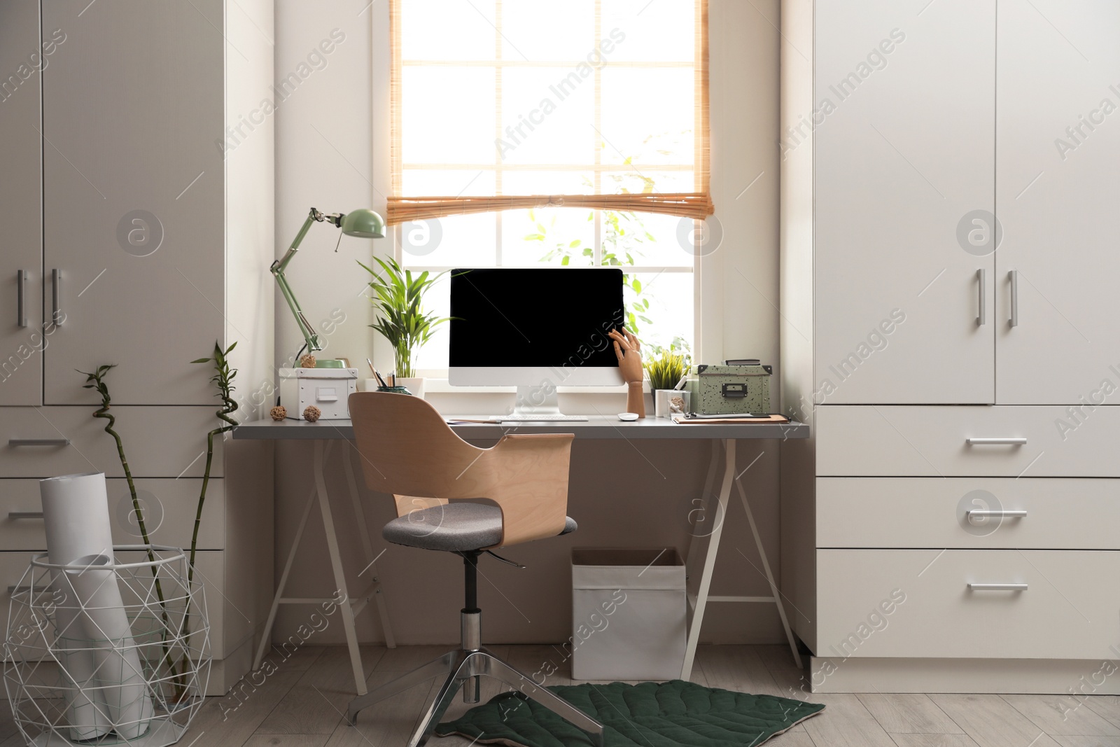 Photo of Light work place with computer near window at home. Interior design