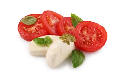 Photo of Delicious Caprese salad with tomatoes, mozzarella cheese, basil leaves and pesto sauce isolated on white