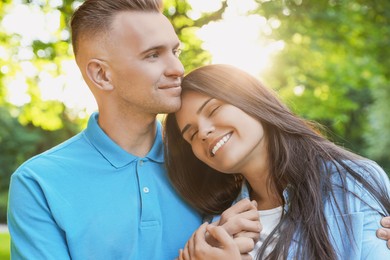 Happy young couple having good time together in park