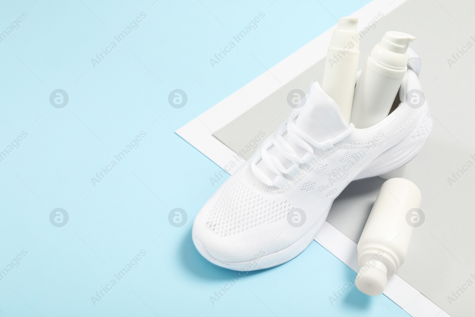 Photo of Stylish footwear with shoe care accessories on color background, above view. Space for text