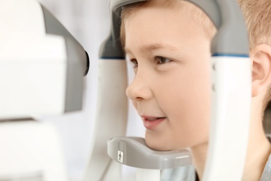 Photo of Little boy visiting ophthalmologist in clinic