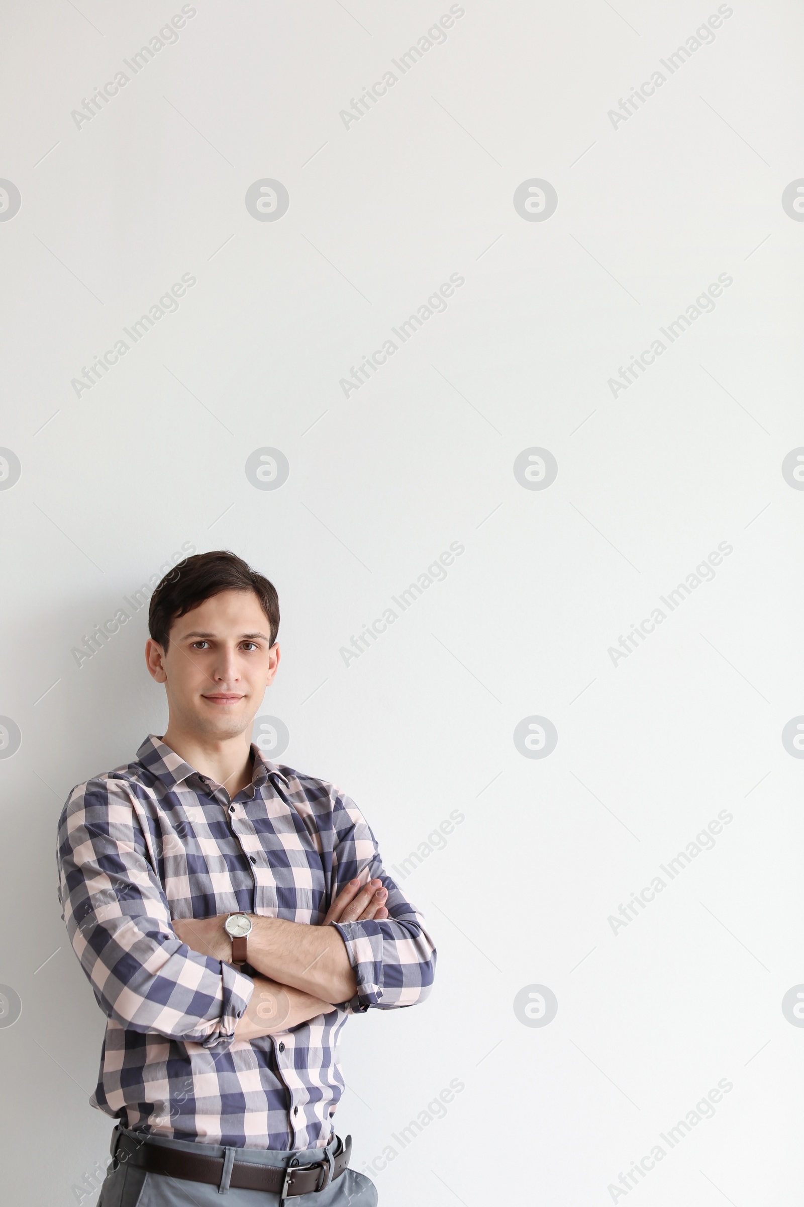 Photo of Portrait of confident young man on light background