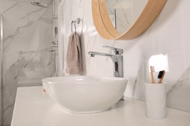 Bathroom interior with mirror, countertop and soft towel on wall