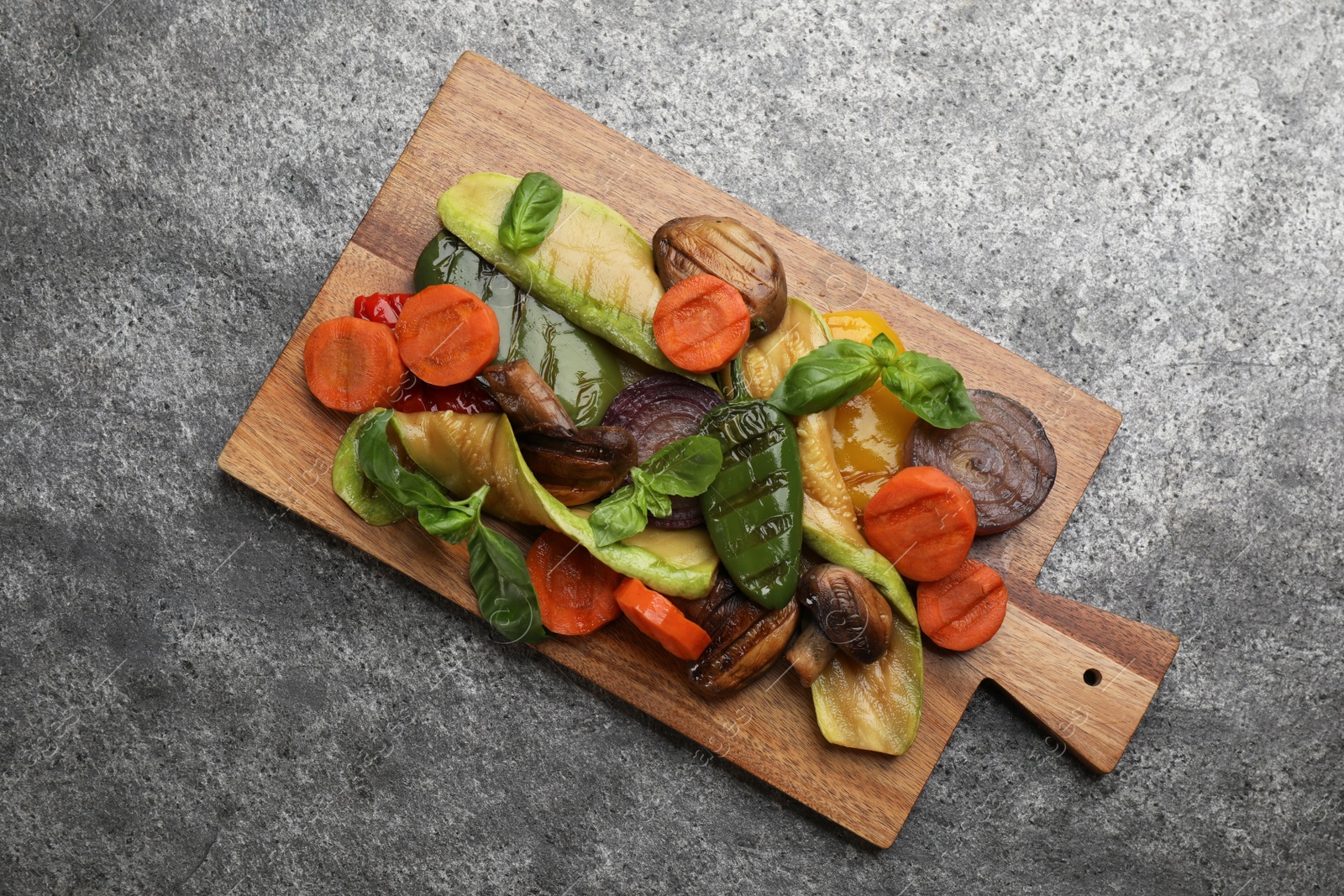 Photo of Delicious grilled vegetables on grey table, top view