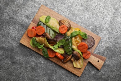 Delicious grilled vegetables on grey table, top view