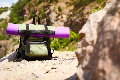 Photo of Backpack with sleeping mat outdoors on sunny day