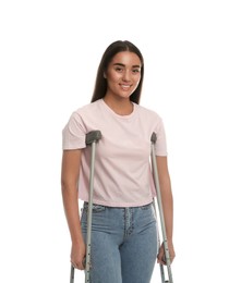 Photo of Young woman with axillary crutches on white background