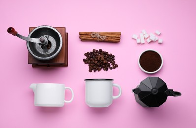 Flat lay composition with vintage manual grinder and geyser coffee maker on pink background