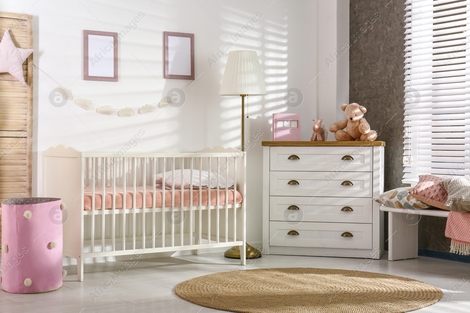 Photo of Cozy baby room interior with comfortable crib