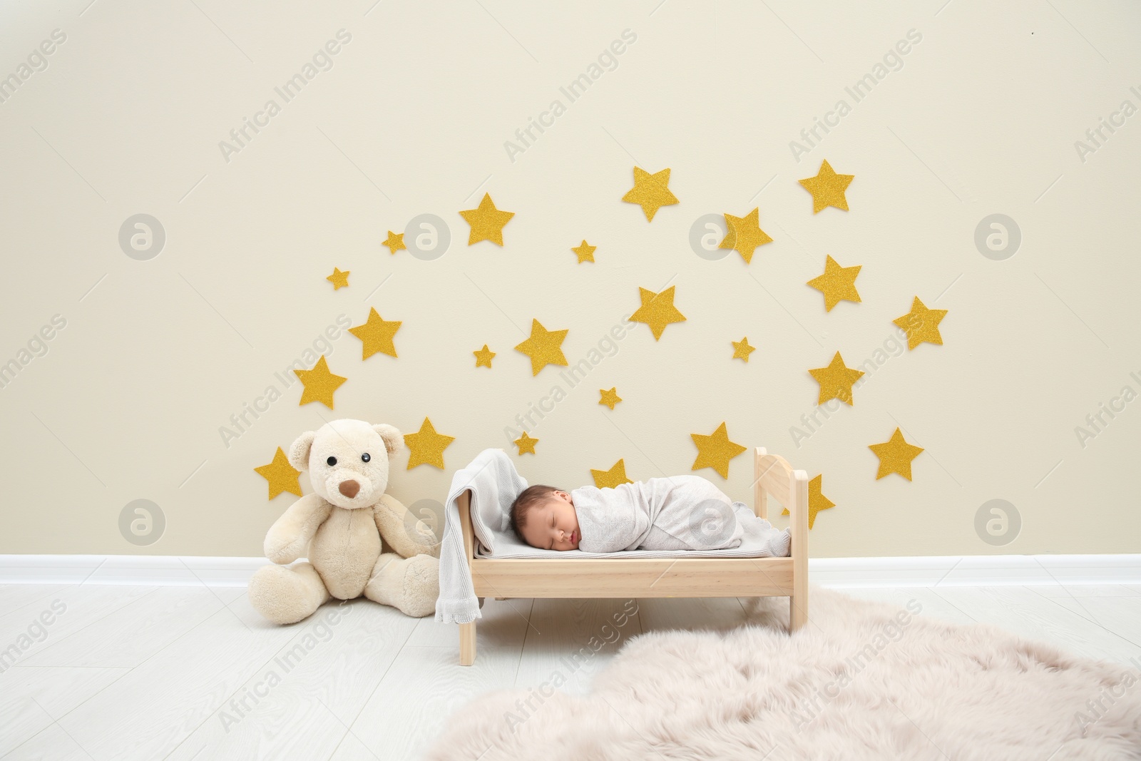 Photo of Adorable newborn baby sleeping in small bed