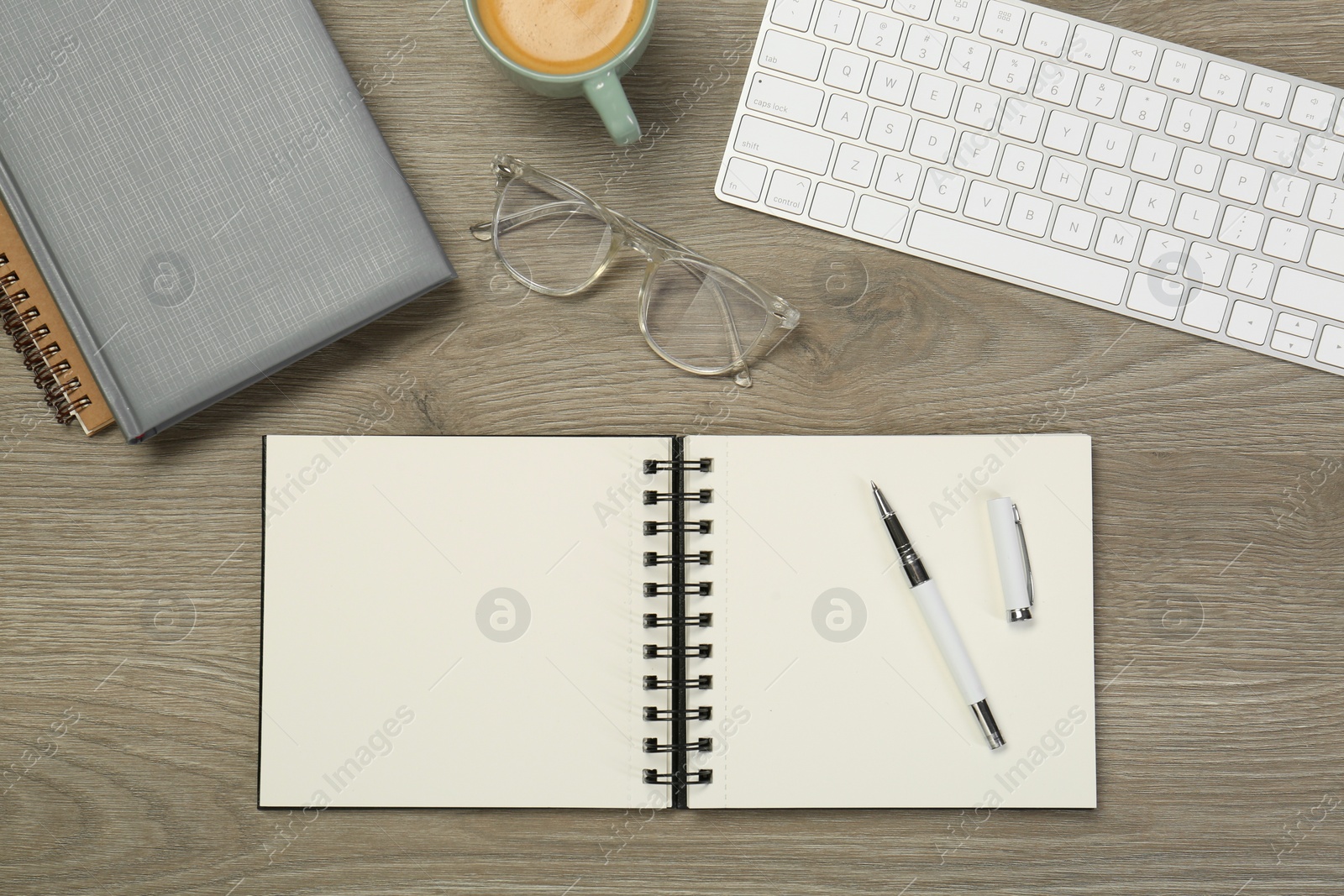 Photo of Flat lay composition with notebooks on wooden table