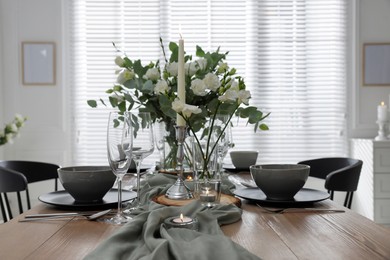 Photo of Festive table setting with beautiful tableware and decor indoors