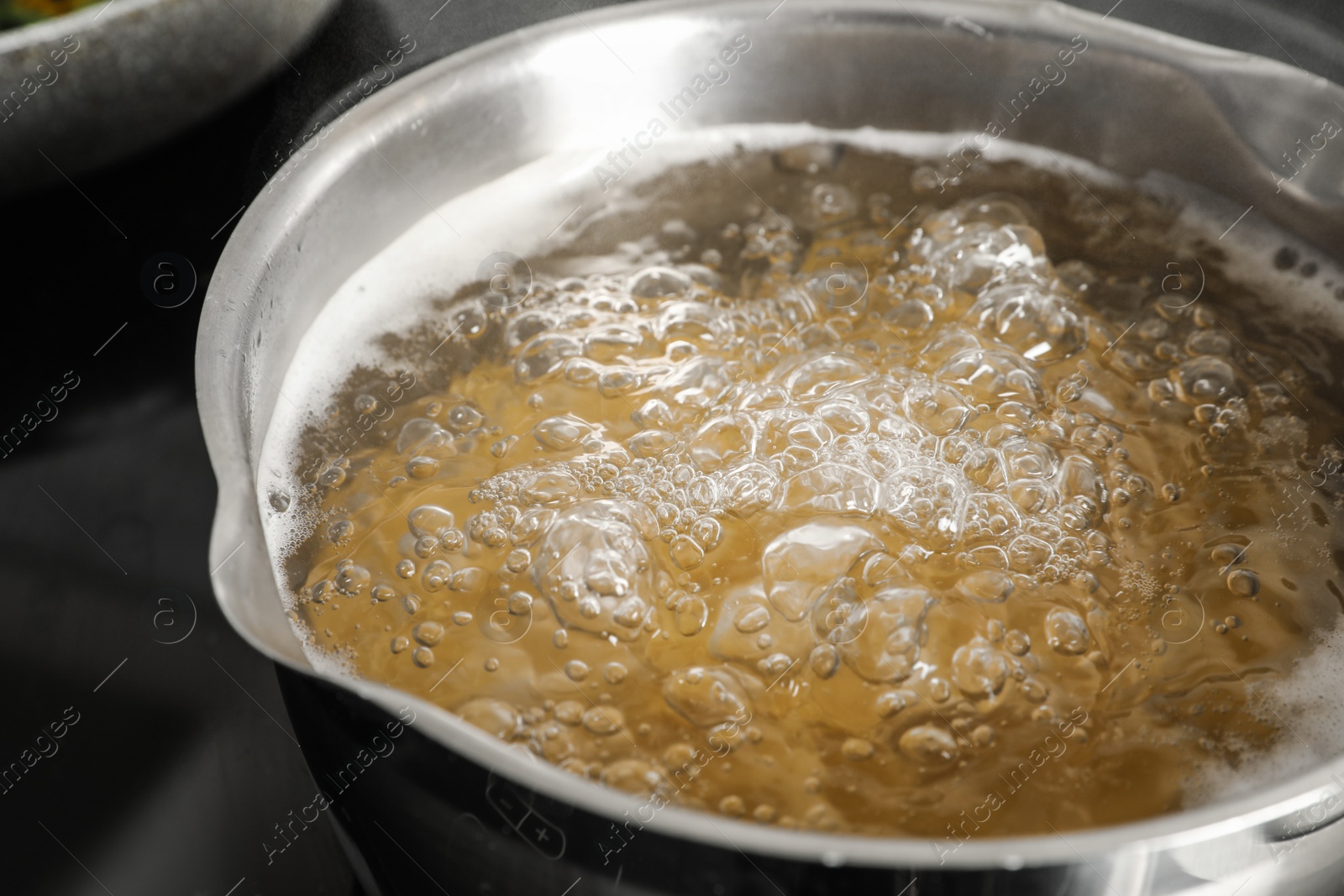 Photo of Cooking pasta in pot on stove, closeup view