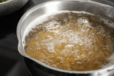 Cooking pasta in pot on stove, closeup view