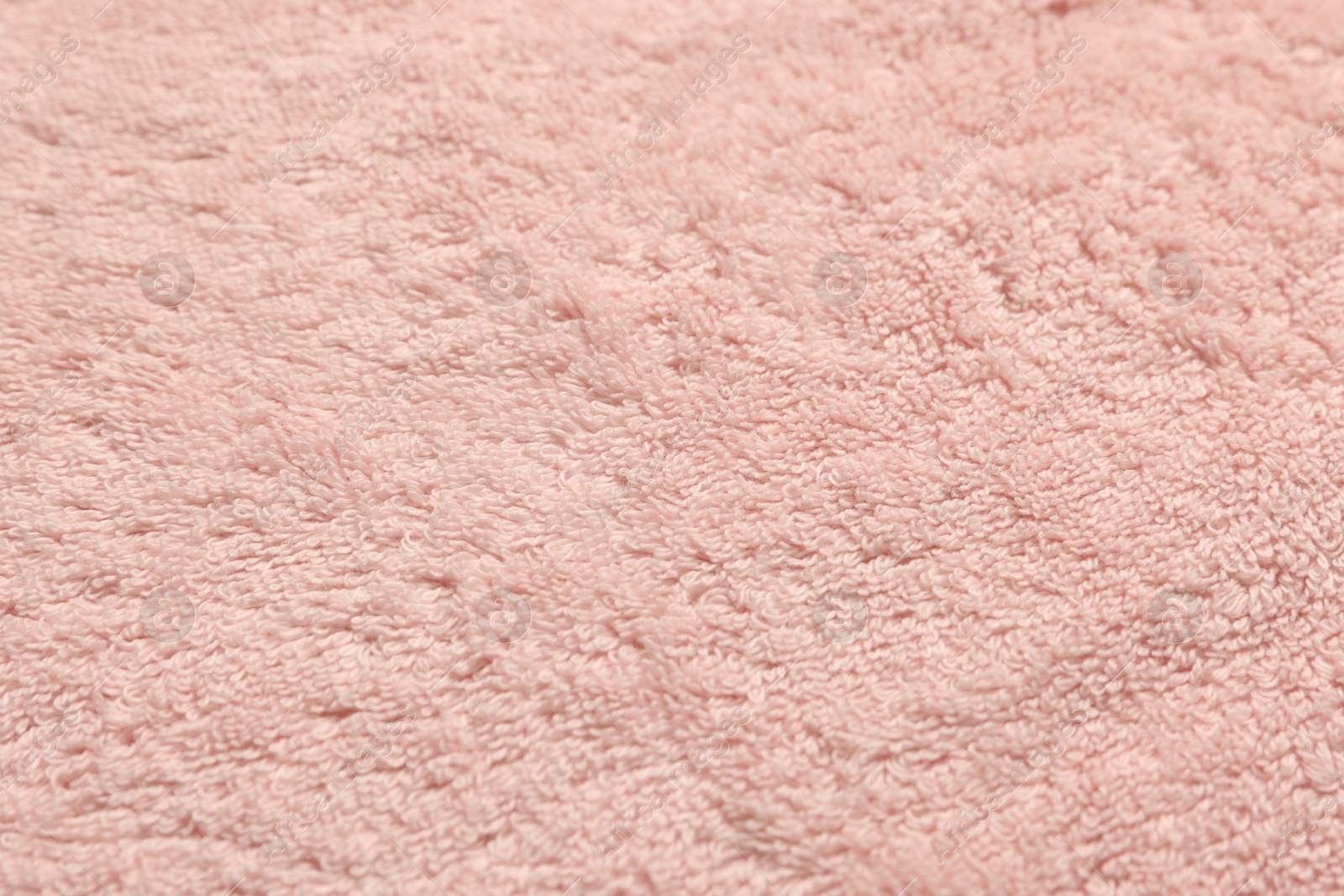 Photo of Dry soft pink towel as background, closeup