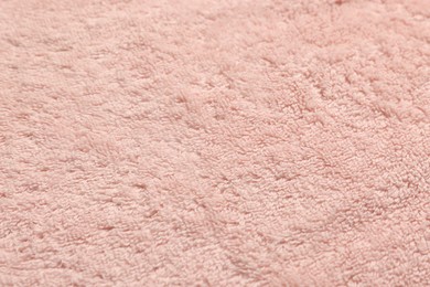 Photo of Dry soft pink towel as background, closeup