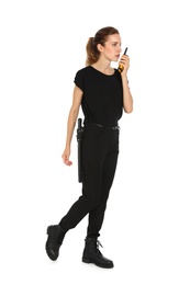 Female security guard in uniform using portable radio transmitter on white background