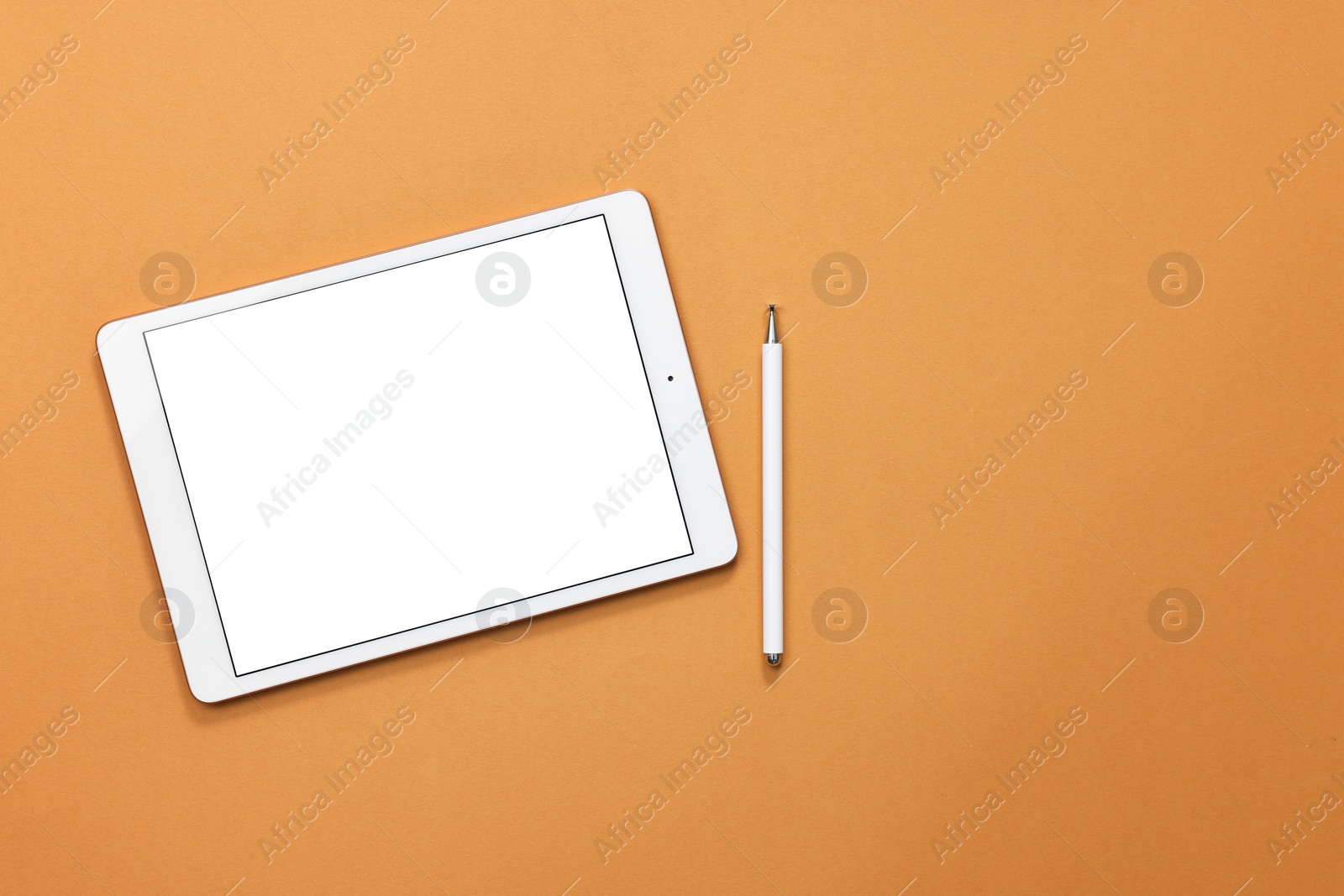 Photo of Modern tablet and stylus on orange background, flat lay. Space for text