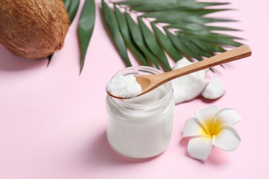 Photo of Beautiful composition with coconut oil and nuts on color background