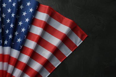 Photo of Flag of USA on black table, top view. Space for text